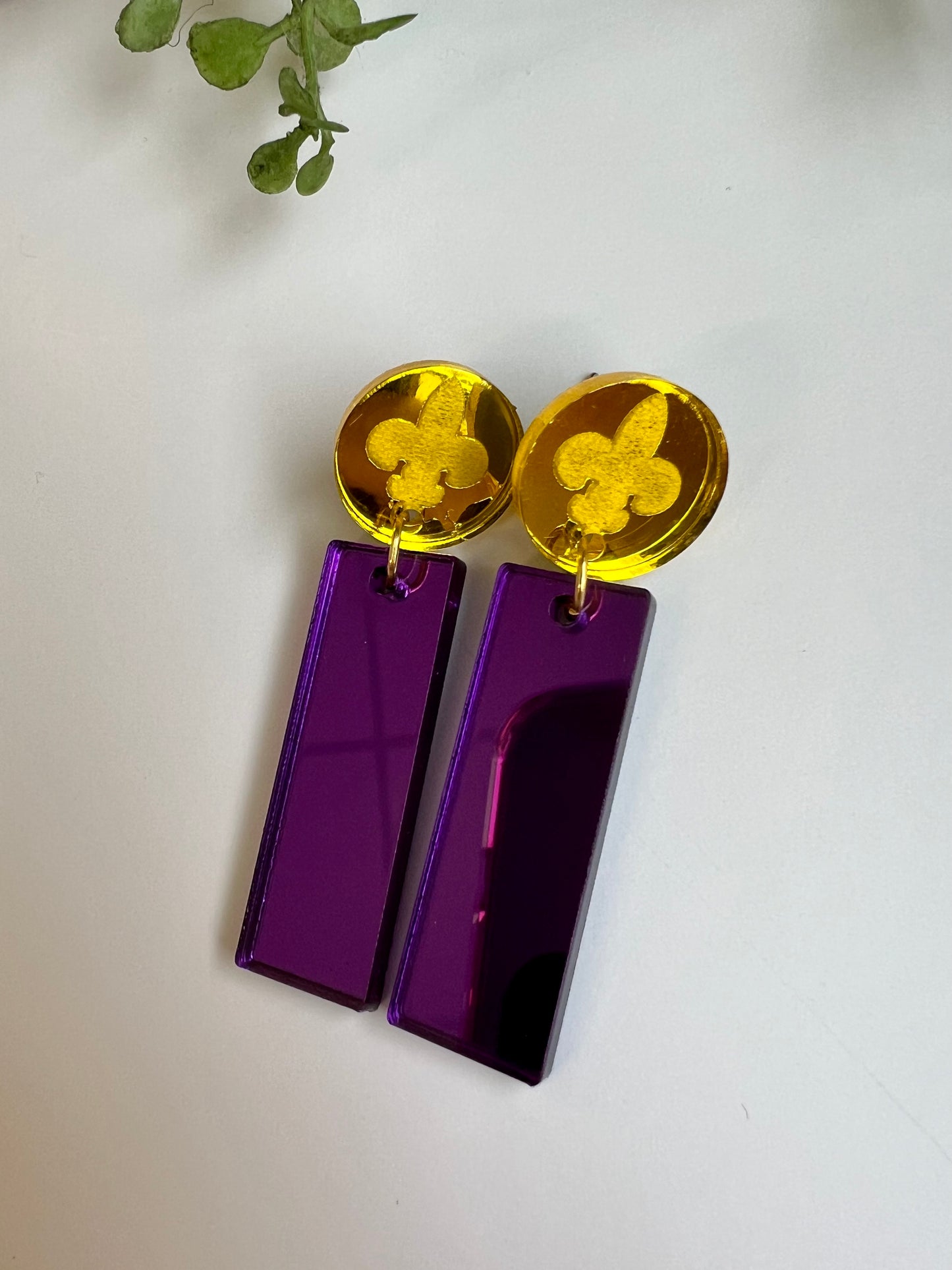 Fleur-de-lis mirror dangle earrings. Gold top.